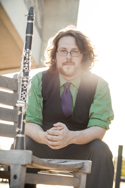 Headshot of Christopher M Culp seated with a clarinet in front of him.